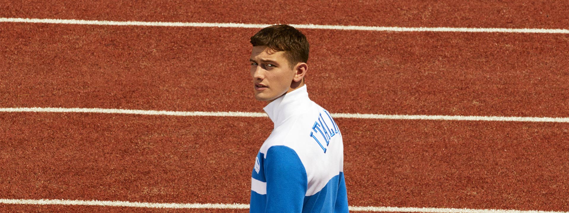 A male model is wearing a white and blue tracksuit from the Spring Summer 2023 Sport collection