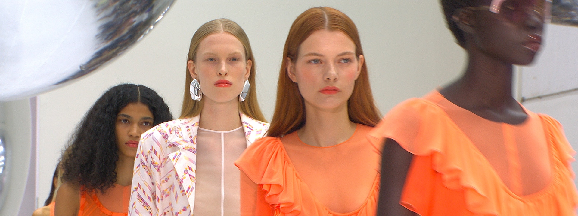 Two models are wearing multicoloured outfits from the new Fall Winter 2023 collection