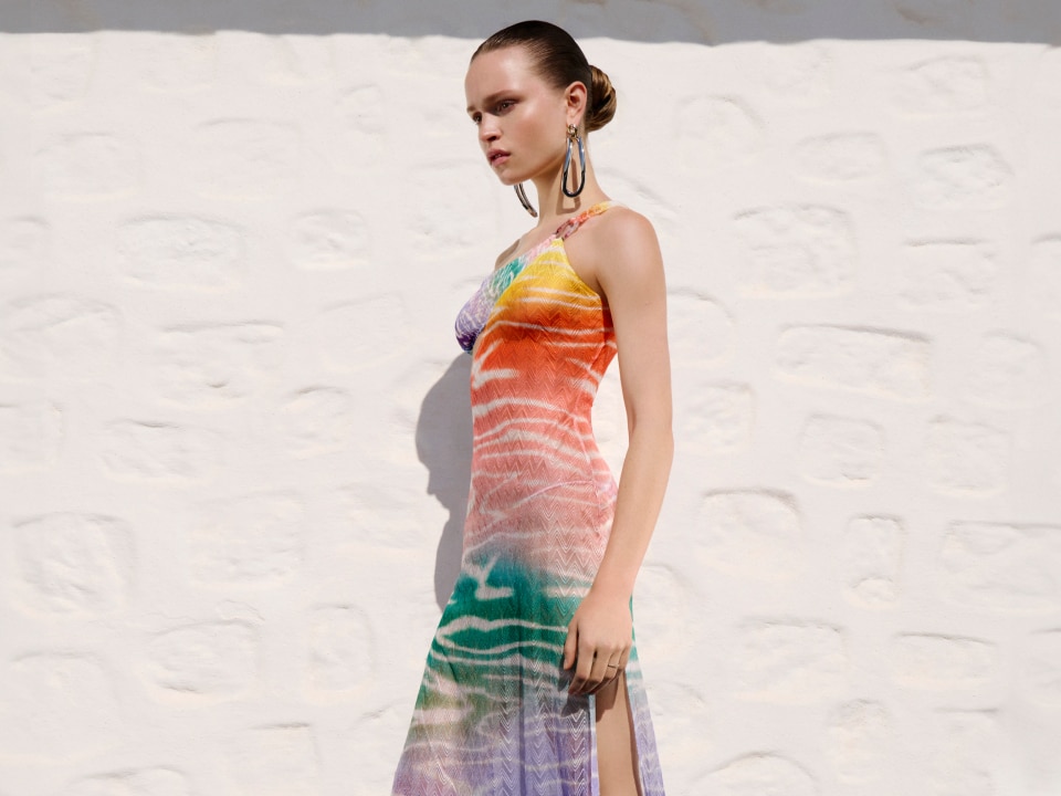 A model is wearing a multicolour cover up