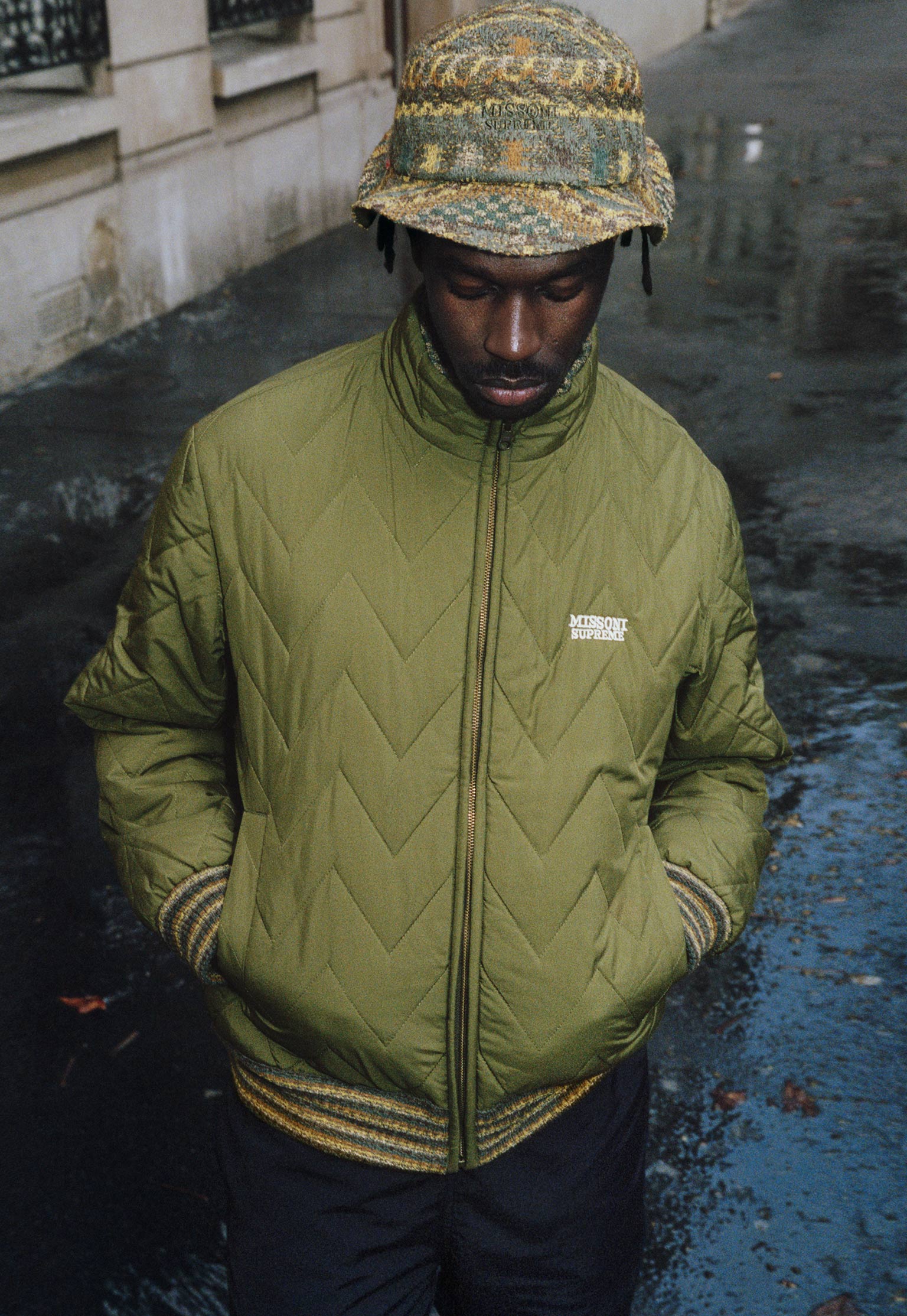 The model is wearing a waterproof jacket that matches the bucket hat