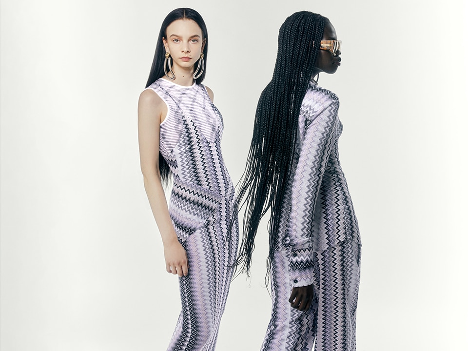 Two models are wearing two dresses from the Fall Winter Show Collection in grey zig zag