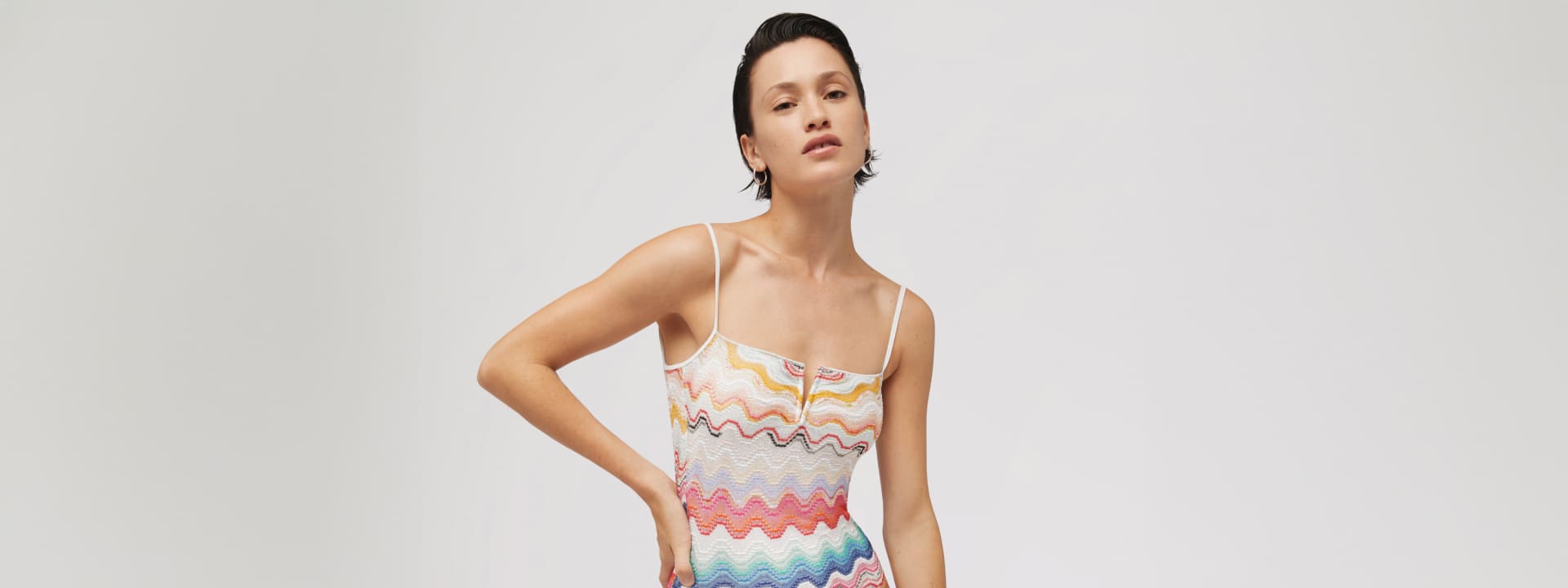 A model is wearing a multicolour zig zag bikini