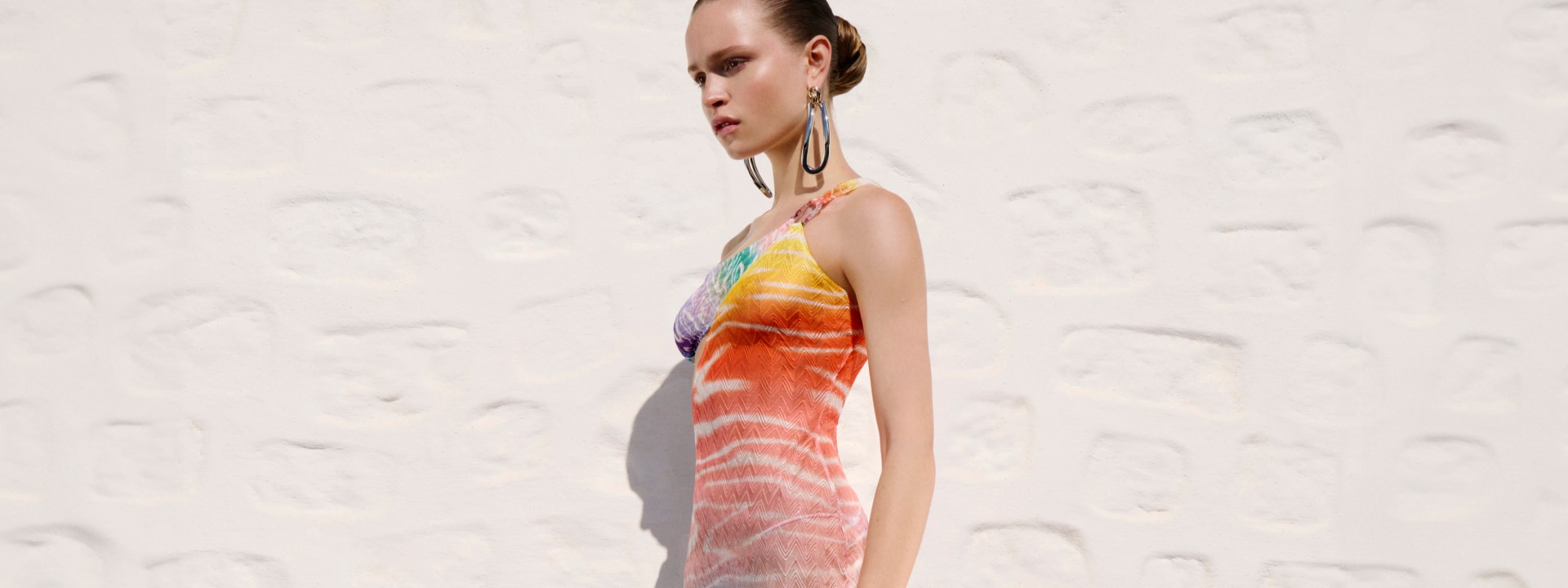 A model is wearing a multicolour cover up