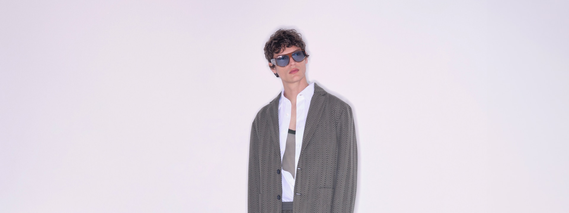 The model wears a gray suit from the new Spring Summer 2023 collection