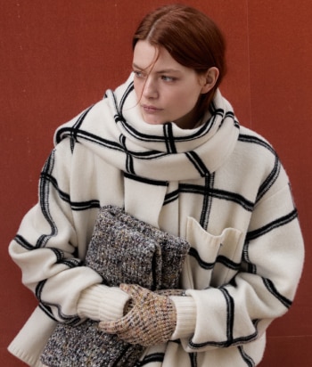 A model is wearing a sleeveless tank top and a pair of trousers, both in zig zag textures