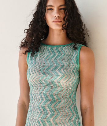 A model is wearing a sparkling jacket in dark tones