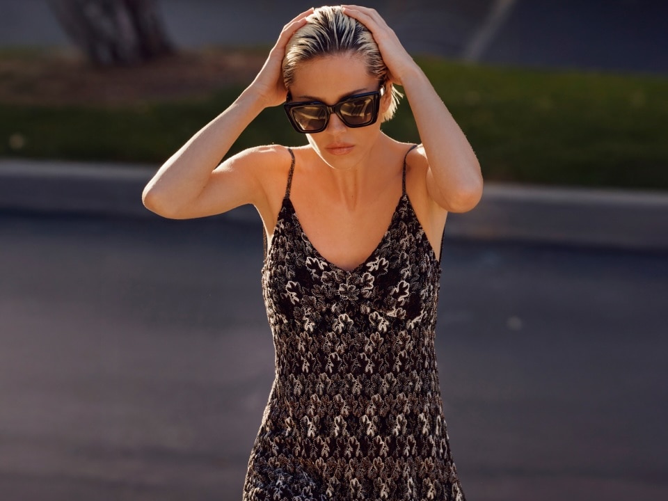 A model is wearing a dress in black and silver colors