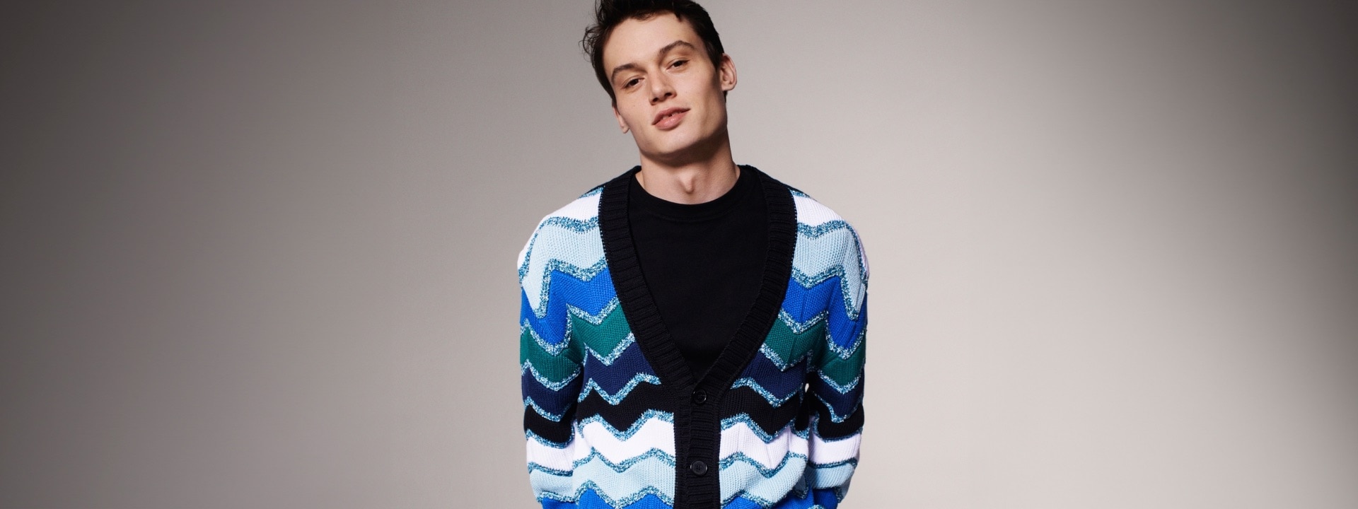 A model is wearing a chunky zig zag blue cardigan