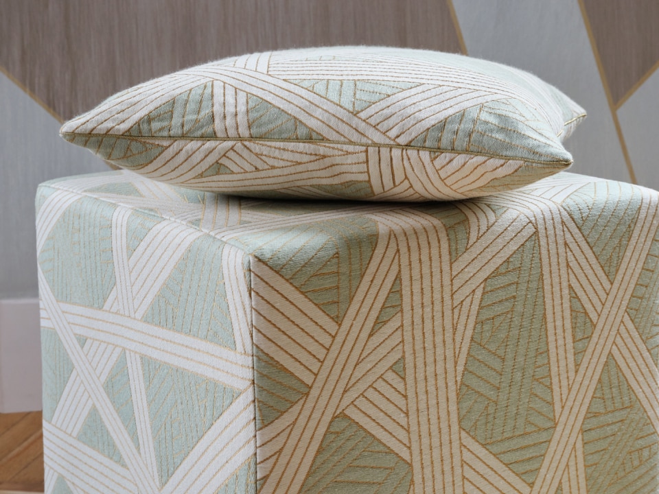 A cushion and a pouff in the green Nastri variant