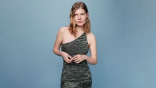 A woman si wearing a short black dress