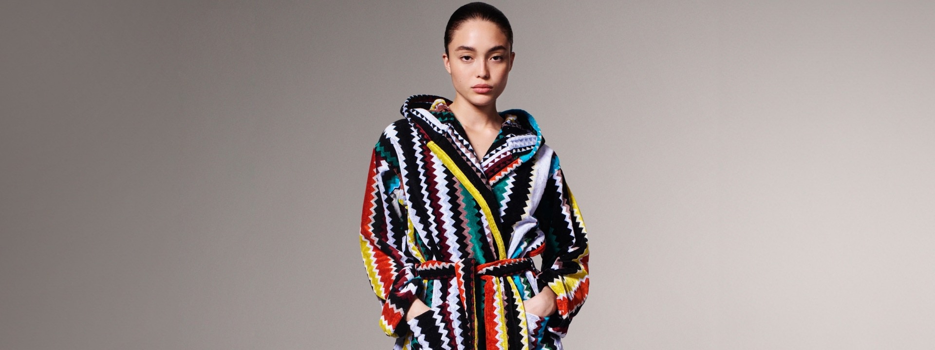 A model is wearing a multicolour zig zag bathrobe